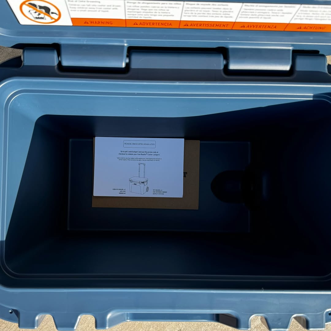Custom navy YETI Roadie 15 cooler with built-in marine speaker and Bluetooth connectivity.